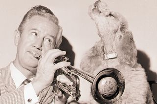 Clyde McCoy plays trumpet for his toy poodle