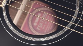 Close up of acoustic guitar strings on a Yamaha acoustic