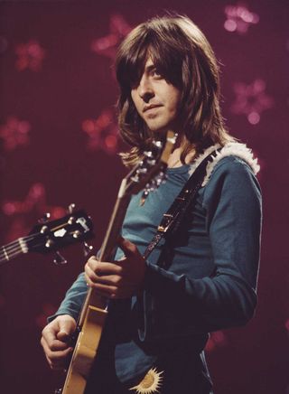 Joey Molland performs onstage with Badfinger in their heyday