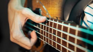 Bassist slapping electric bass guitar