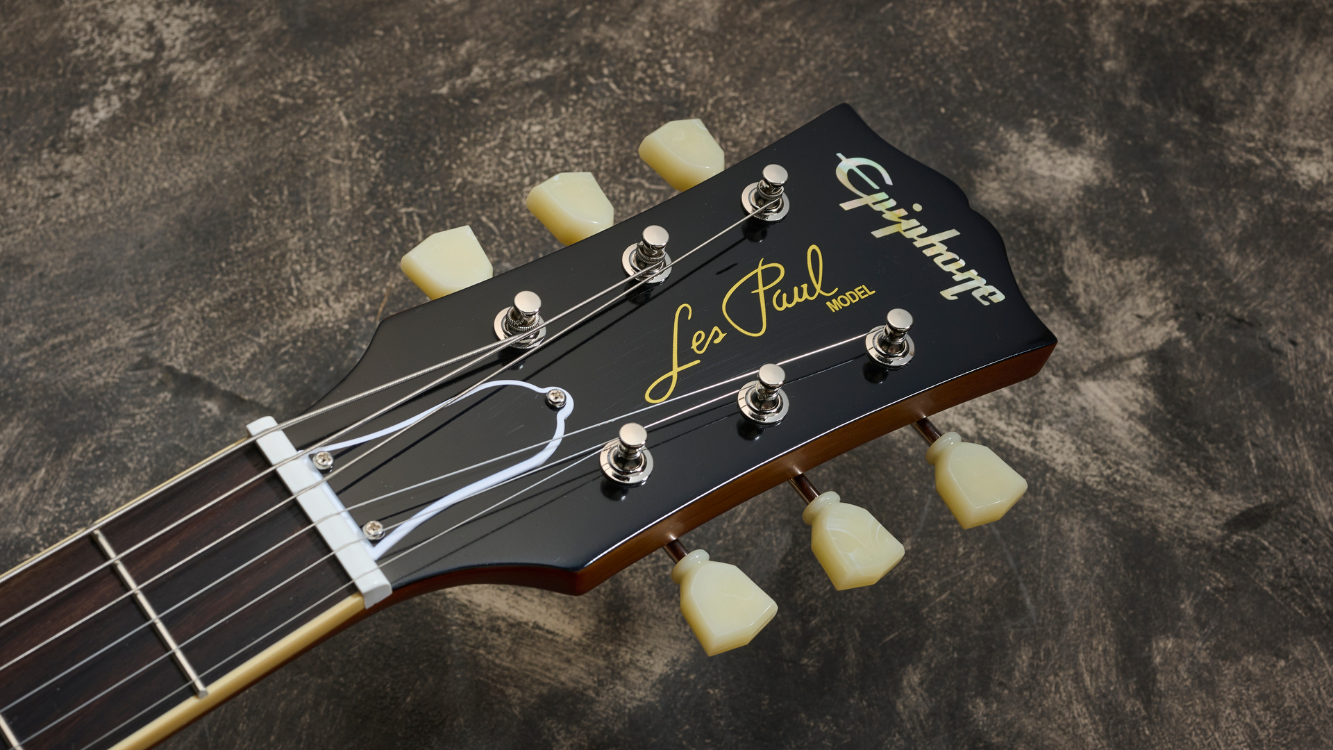 The headstock of the Epiphone Inspired By Gibson Custom Les Paul Goldtop