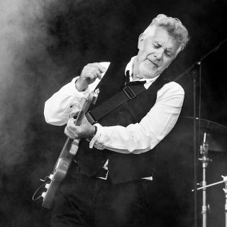 Mick Rogers performs onstage