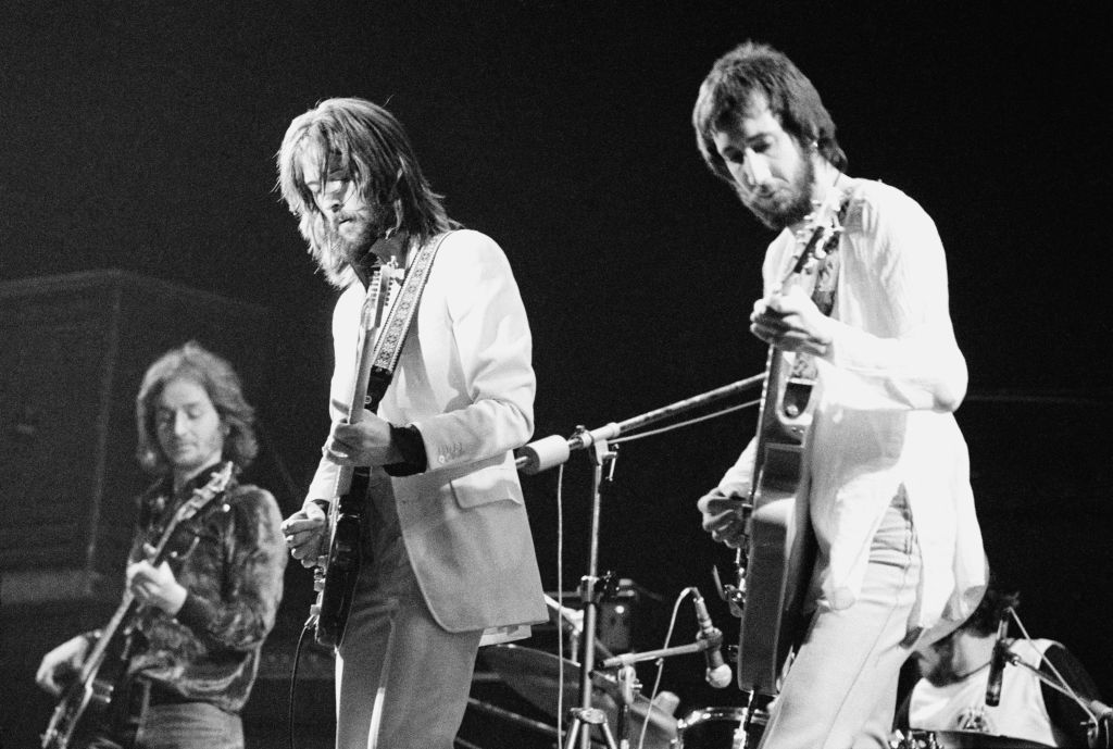 English guitarist Eric Clapton (centre) performing with an all-star line-up at the Rainbow Theatre in London, 13th January 1973. Left to right: Ric Grech, Clapton and Pete Townshend. The concert was organized by Townshend and marked Clapton's comeback after a period of heroin addiction. The concert was released as the live album 'Eric Clapton's Rainbow Concert', later that year