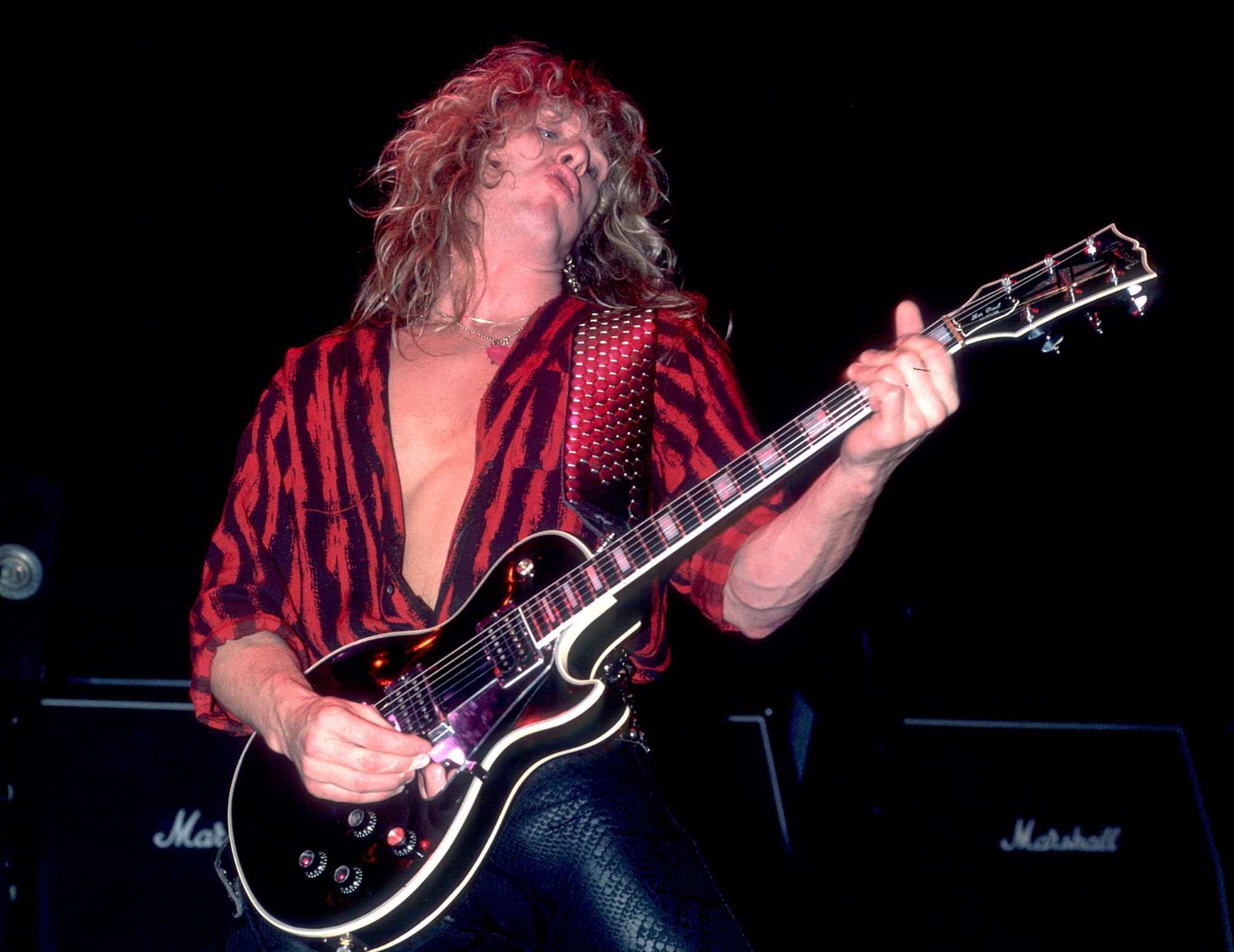 John Sykes performs onstage with Whitesnake at the Reunion Arena in Dallas, Texas on October 21, 1984