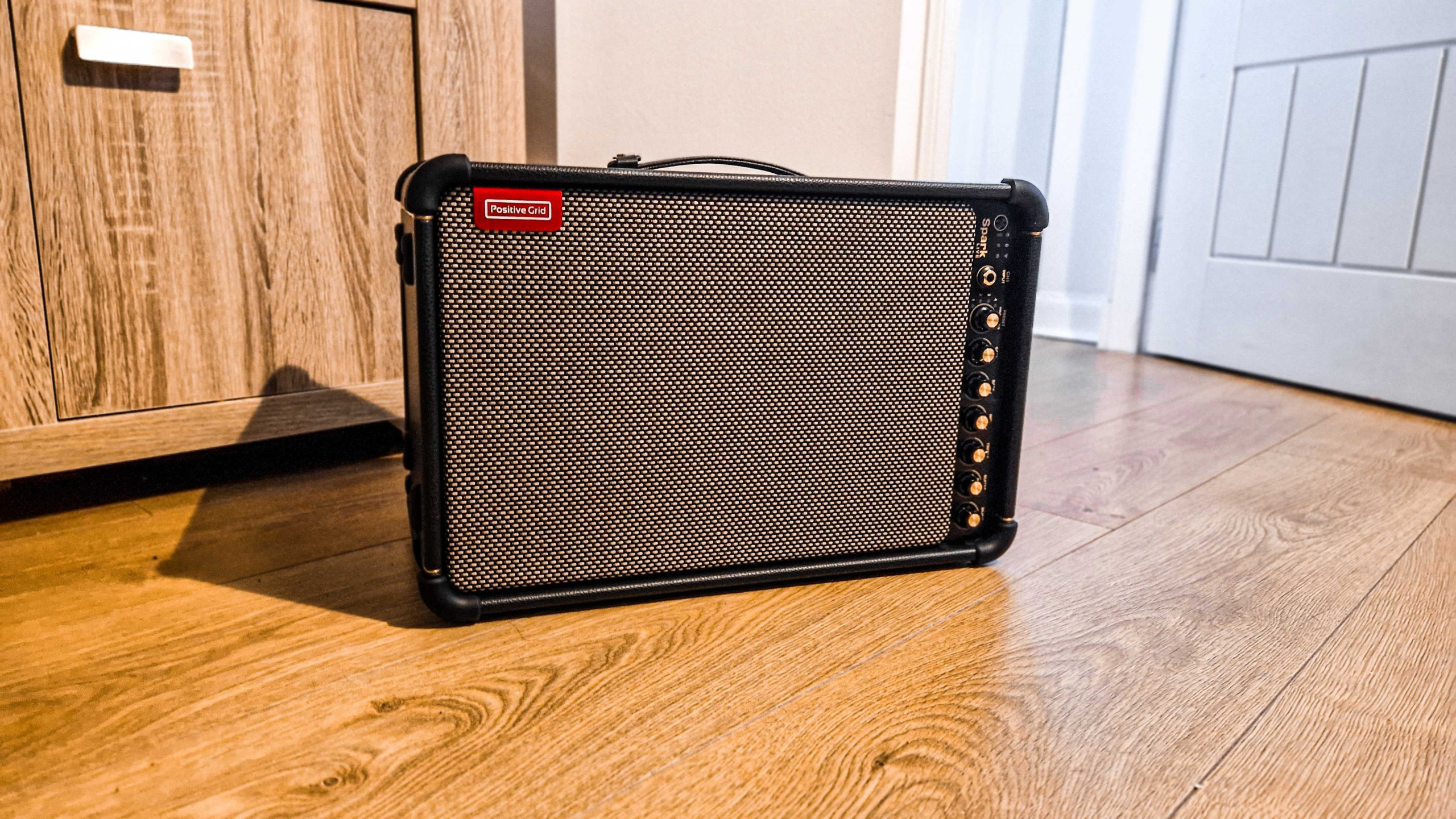 A Positive Grid Spark Live on a wooden floor