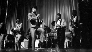 1964: "Godfather of Soul" James Brown performs with The Famous Flames (on left, Johnny Terry, Bobby Byrd, Bobby Bennett) at the Apollo Theater in 1964 in New York, New York.