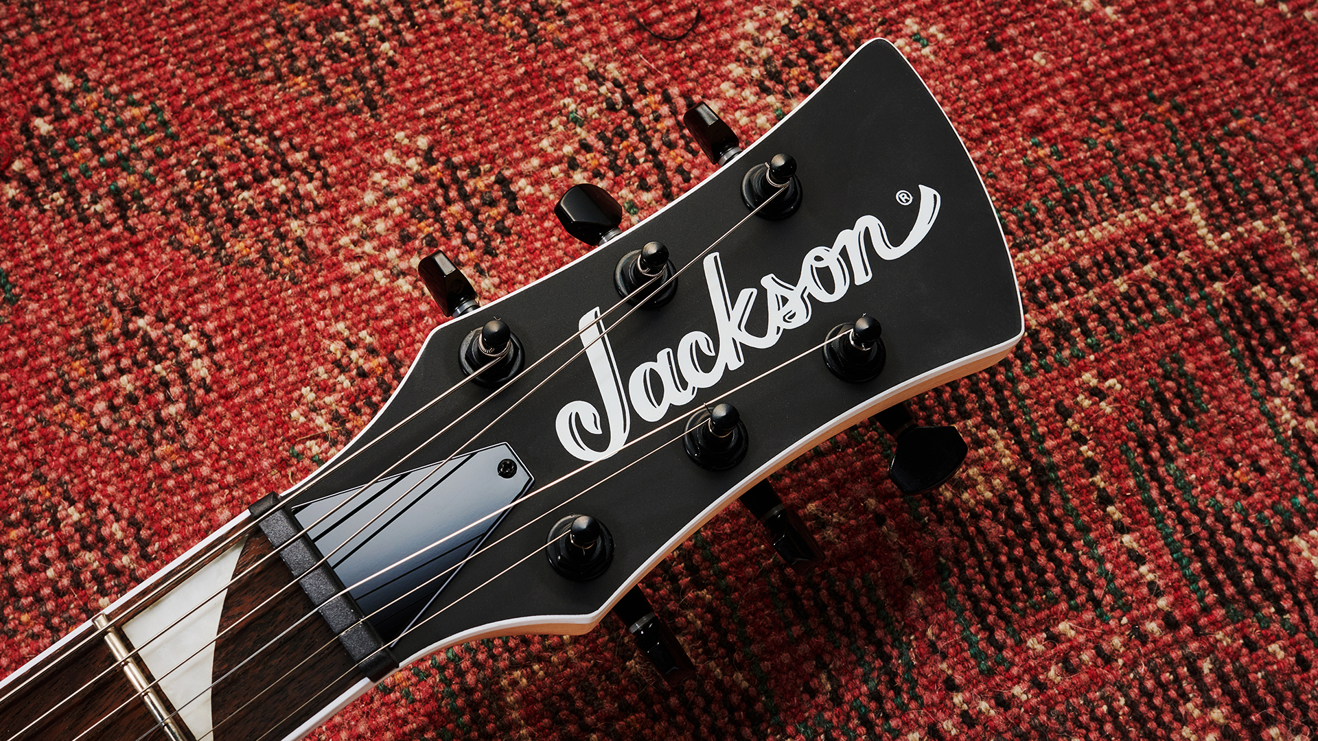 The headstock of the Jackson X Series Surfcaster