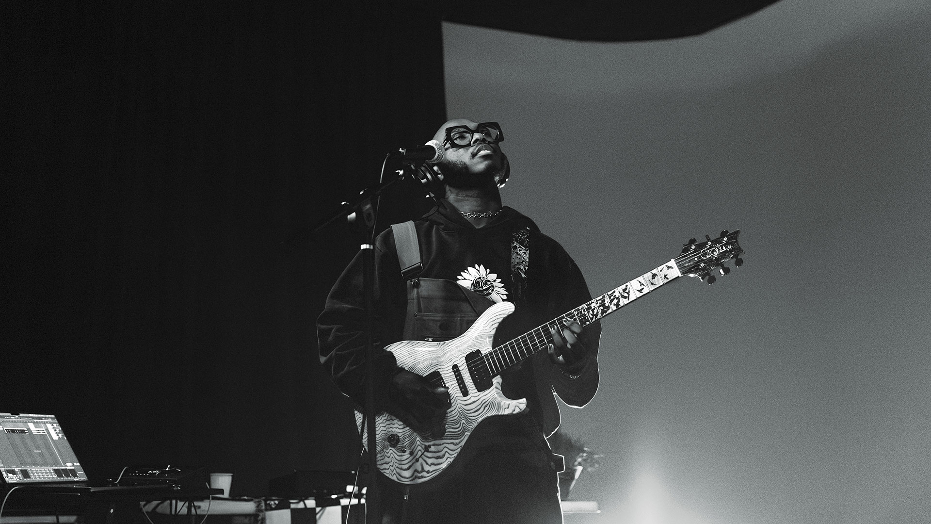 Black and white photo of Justus West playing guitar