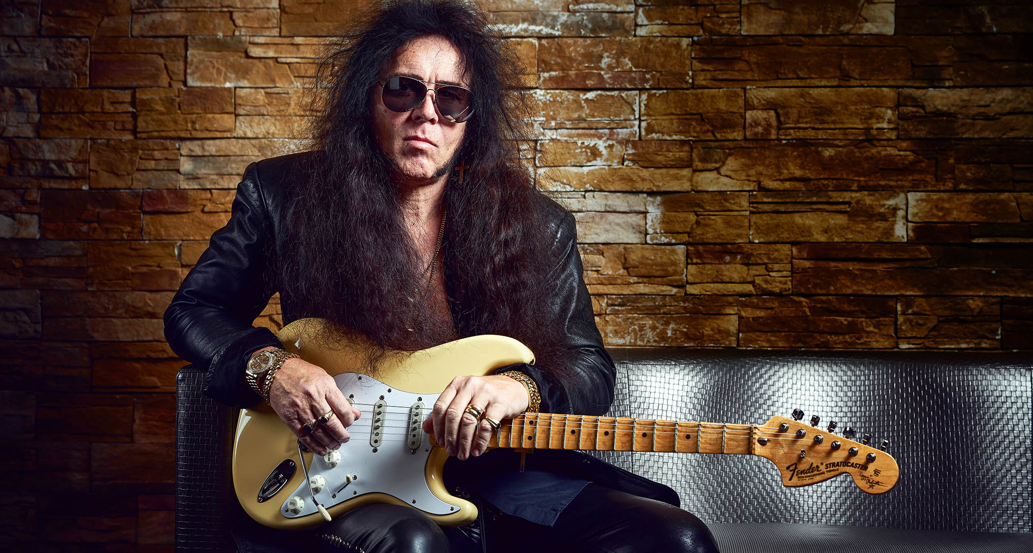 Yngwie Malmsteen is wearing aviator sunglasses and holds his signature Fender Stratocaster &ndash; a guitar that he promises you is the best you will ever find.